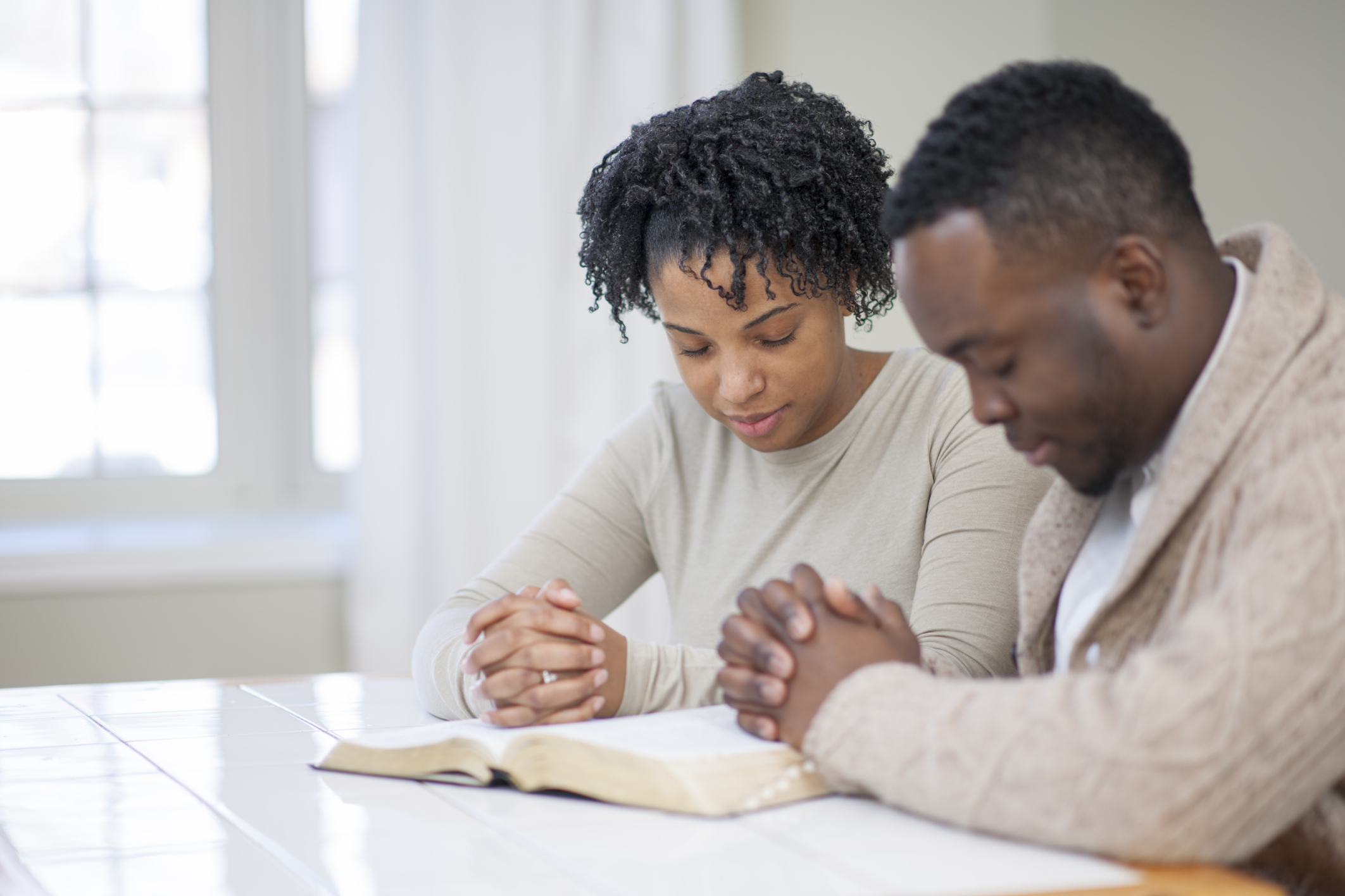 Religious Ethnic Couple Praying with a Bible