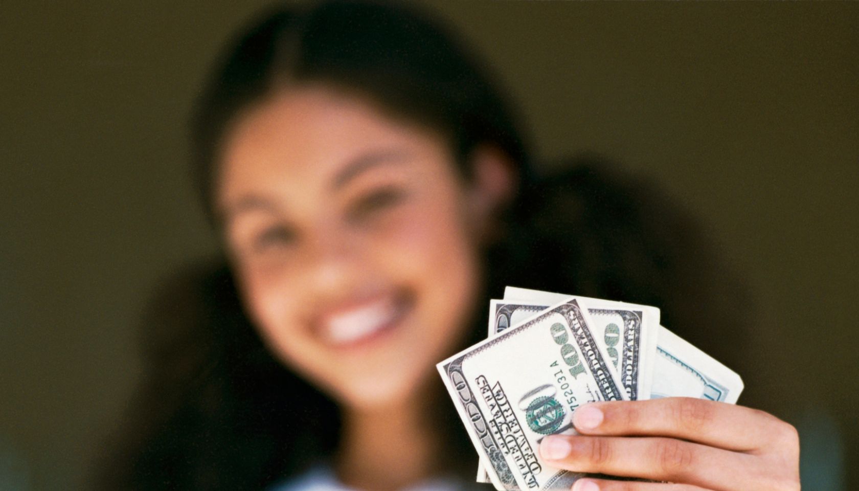 Woman holding US currency