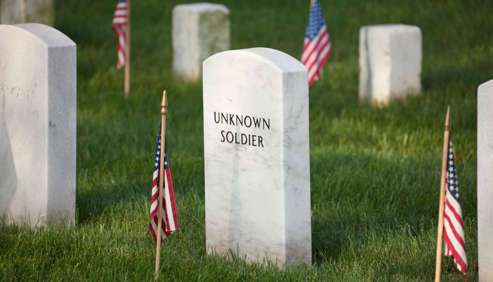High Angle View Of American Flags And Tombstones At Arlington National Cemetery