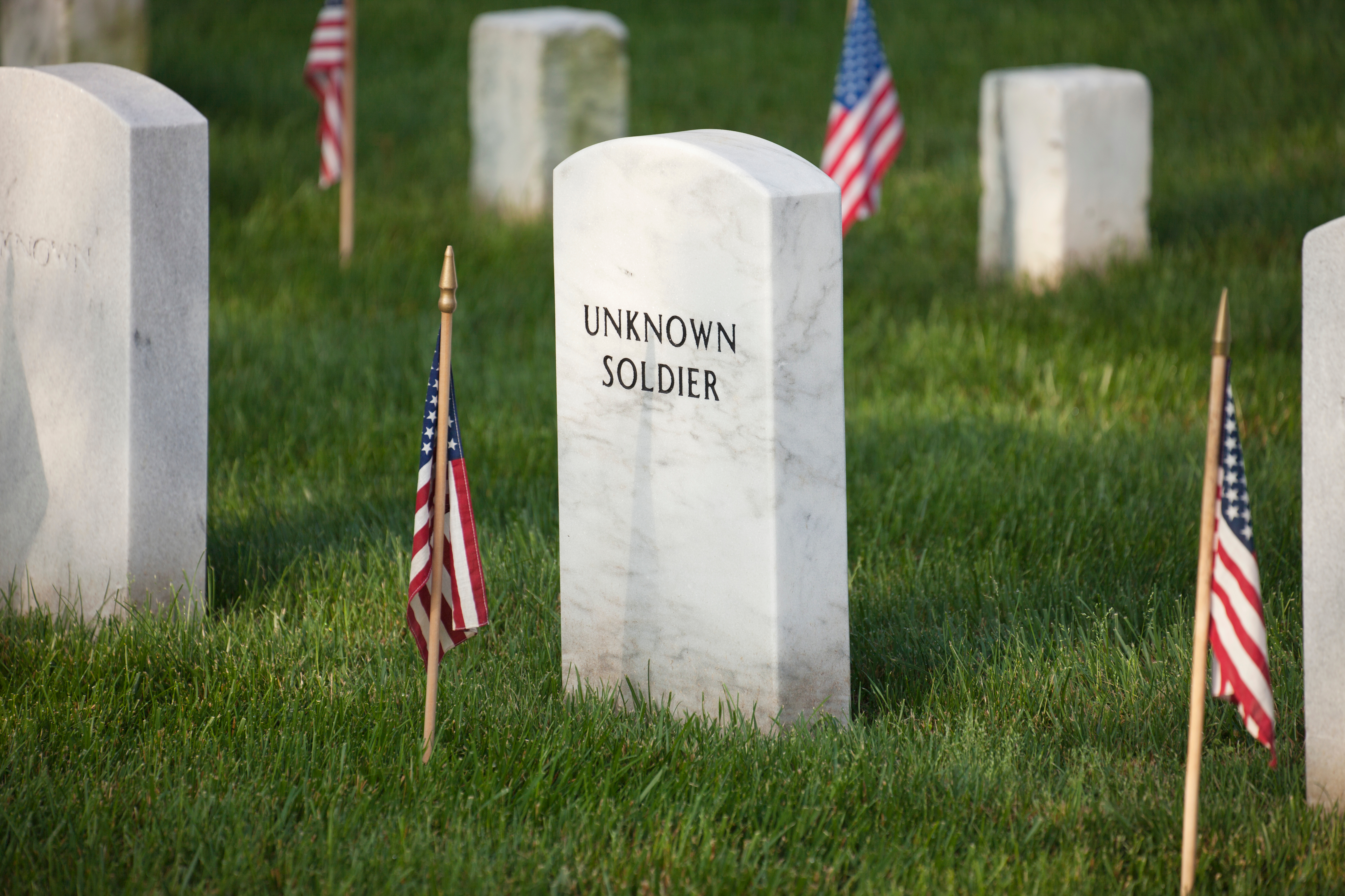 High Angle View Of American Flags And Tombstones At Arlington National Cemetery