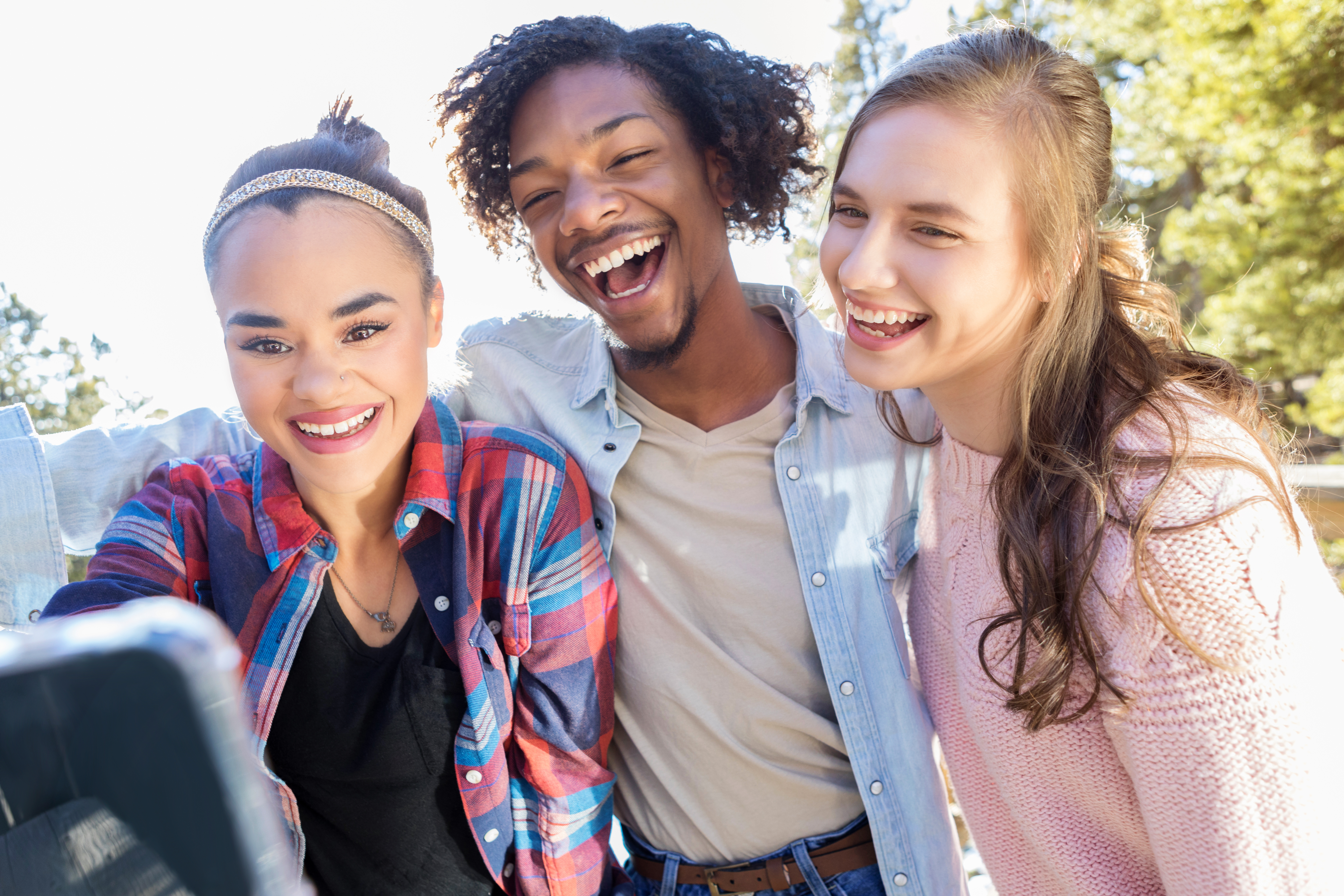 Young adult friends enjoy social media app together