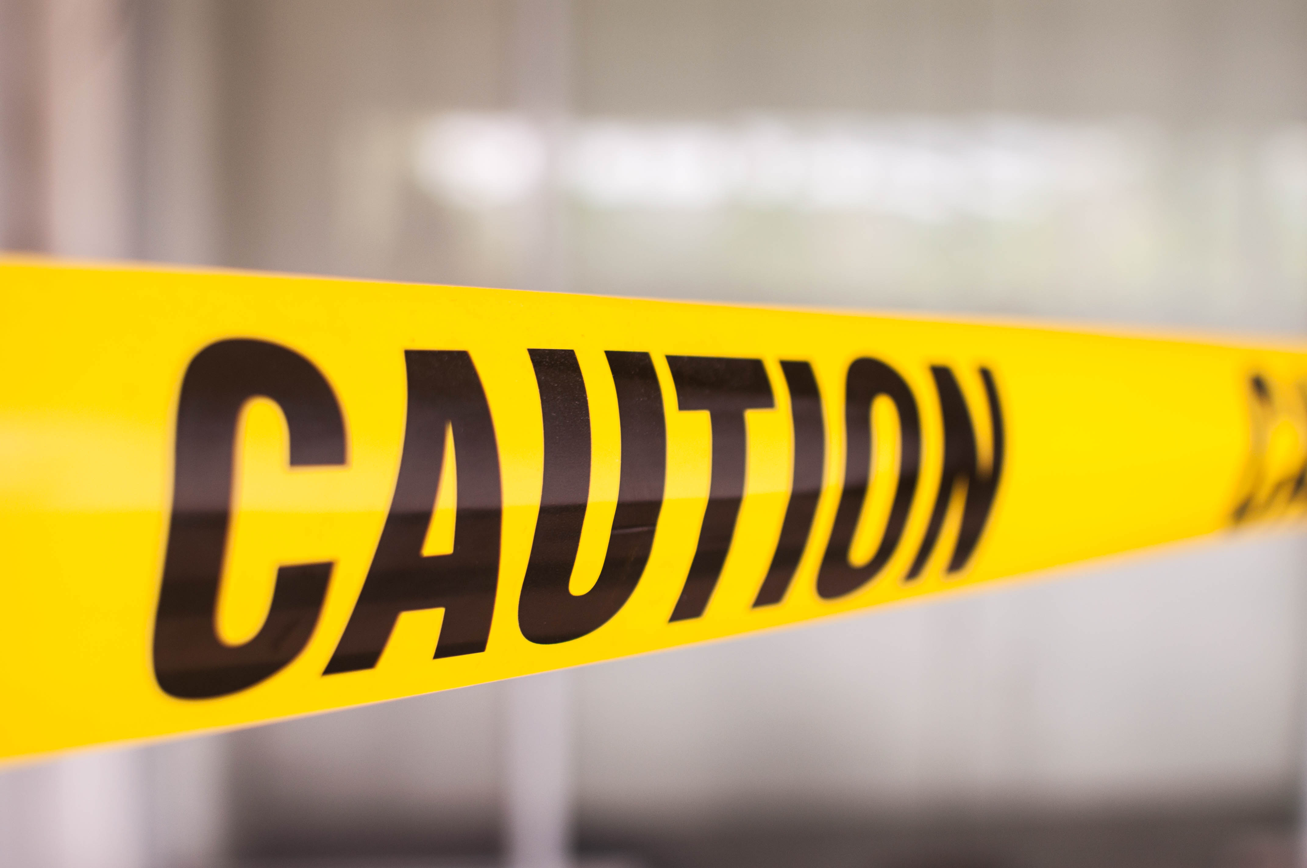 Yellow tape with caution sign