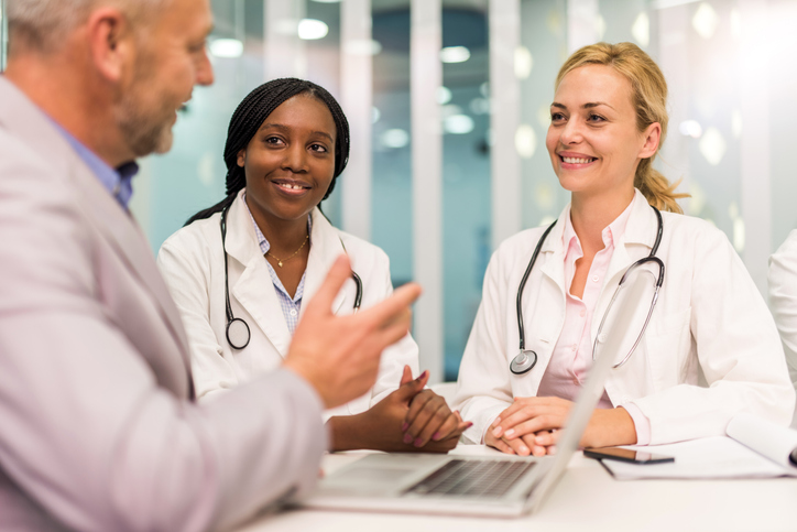 Young female doctors having a meeting with businessman.