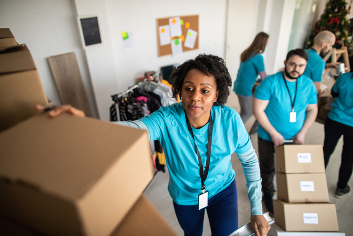 African woman taking donation box from shelf