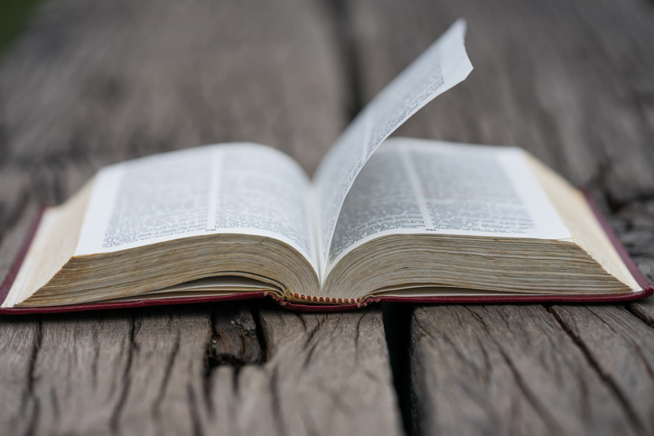 Open bible on wood background