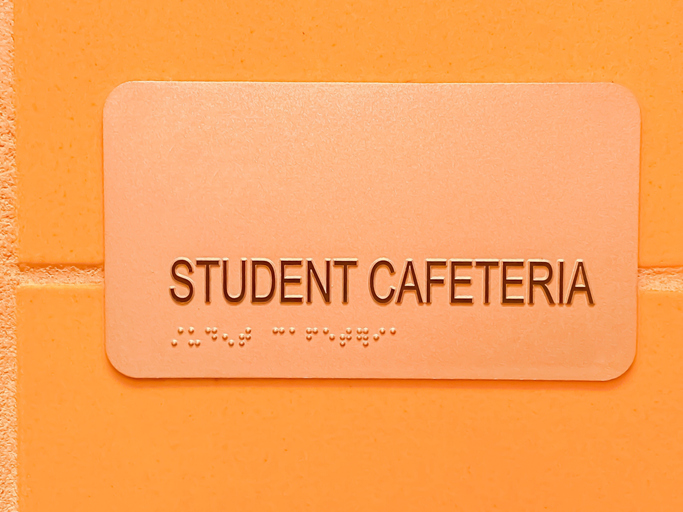 school cafeteria sign including braille alphabet