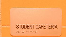 school cafeteria sign including braille alphabet