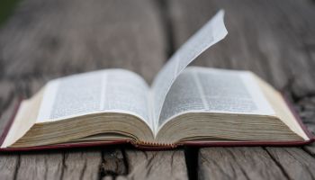 Open bible on wood background