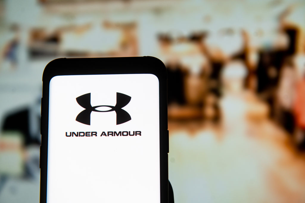 In this photo illustration an Under Armour logo seen...