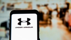 In this photo illustration an Under Armour logo seen...