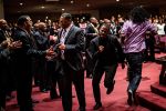 Congregants react to Ricky Dillard's music direction and Rev. Tye Tribbett's sermon at Ebenezer African Methodist Episcopal in Fort Washington, Maryland...