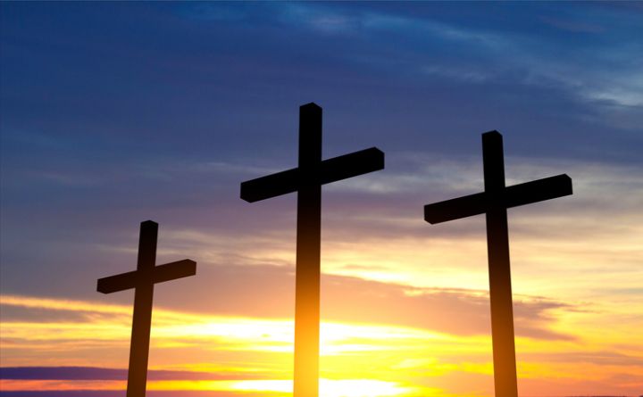 Crucifixion Of Jesus Christ at sunrise. Three crosses on hill